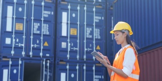 女工程师在航运港口使用数字平板电脑处理货运集装箱