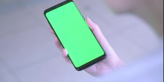 空白数字智能手机在亚洲女性手中，手机绿屏