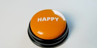 年轻女子按着橙色光滑的快乐按钮。按压它可以改善心情。祝好运，求财运。