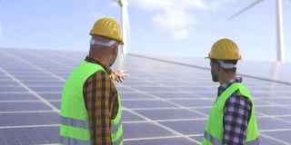 在太阳能发电站的工人-太阳能板与风力涡轮机背景-绿色能源可再生的概念