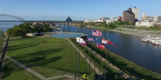在泥岛河公园七根旗杆上挥舞旗帜，孟菲斯，田纳西州。赫尔南多·德索托大桥和密西西比河的背景