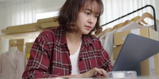 年轻迷人的亚洲女性潮人深思的严重怀疑的感觉压力担心金融问题在中小企业危机小企业的挑战冲击在家里的办公室。