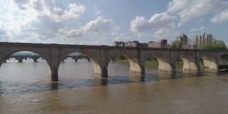 历史悠久的胡桃街铁路桥，市场街桥，以及其他横跨萨斯奎哈纳河的桥梁，在宾夕法尼亚州哈里斯堡市中心的远处可以看到。无人机制作的航拍视频，带有电影的渐增平移摄像机运动。