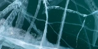 在结冰的贝加尔湖上快速滑雪。蓝色透明的冰，有很深的裂缝。