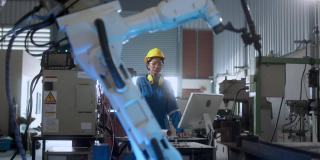 工程师配合男女技术员维修控制继电器机器人手臂系统焊接用平板电脑控制质量操作过程工作重工业4.0制造工厂