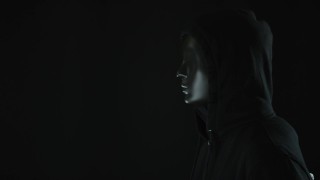 男人戴着黑色的面具，光揭示了暗网的单词视频素材模板下载
