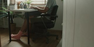 残疾人在家用笔记本电脑工作。