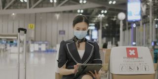 亚洲年轻女活跃的乘务人员与保护面罩接电话加入队友在门口股票视频