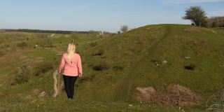 在瑞典Skåne，一个女人在徒步旅行途中穿过令人惊叹的风景