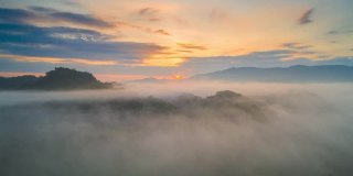 超高延时视频4k，鸟瞰图美丽的晨光日出和薄雾在高山上流动。