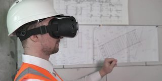 建筑设计师用3D虚拟现实VR眼镜设计一个房间。建筑业的新技术。