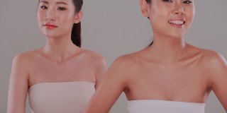 美丽的面孔，两个亚洲年轻女性自然的皮肤。一对漂亮的姑娘，皮肤白皙，皮肤黝黑。