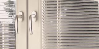 用热湿蒸汽清洁器清洁百叶窗。公寓住宅工作保持清洁理念。