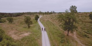 公路与两个旅行者骑马在广阔的田野与天空的景象