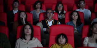 坏习惯:粗鲁的亚洲中国老人在电影放映期间大声讲电话，在黑暗中打扰和忽视他周围的其他观众。一个女孩把手指放在嘴唇上，轻拍他的肩膀，让他保持安静