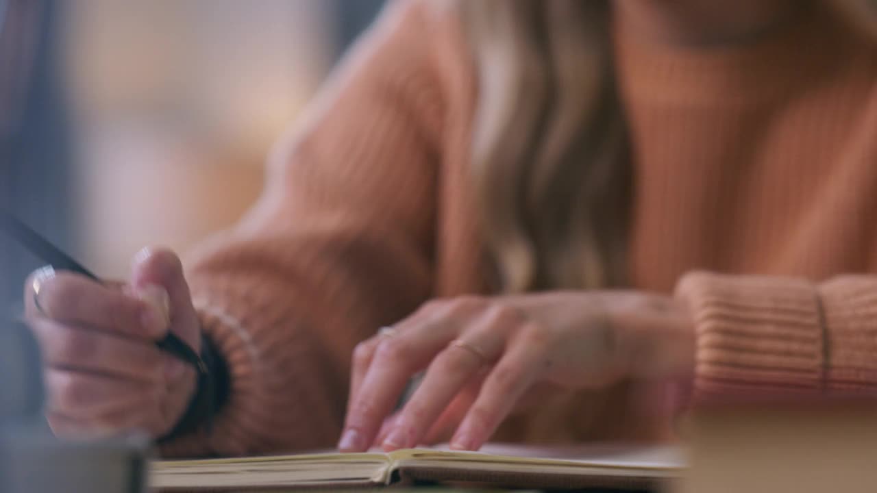 一个年轻女子一边学习一边做笔记的4k视频片段