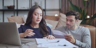 家庭财务，夫妻一起讨论纸账单收据和许多问题和债务家庭内部背景的压力和困惑