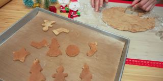 速度前景:亚洲妇女用手按金属模具自制圣诞树饼干、姜饼、甘蔗糖、星星从面团庆祝圣诞节的十二月。