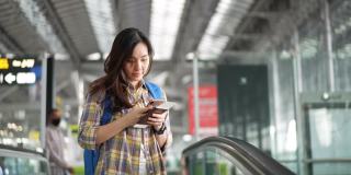 女游客在机场使用智能手机