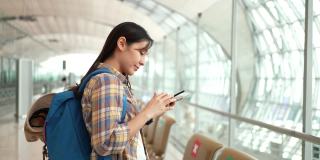 女游客在机场使用智能手机