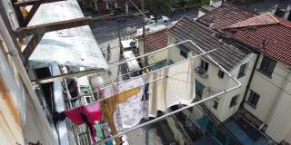 中国上海，中国妇女把洗好的衣服挂在窗户上晾干