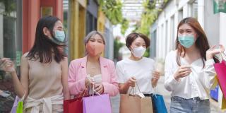 4K群亚洲女性朋友带着医用口罩一起逛街市。