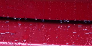 红色汽车表面的雨滴镜头