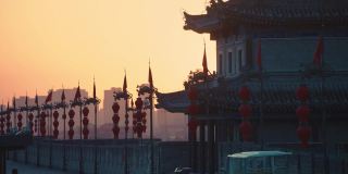 中国，陕西，西安，日落时古城墙上的龙旗和灯笼