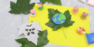 孩子为地球日雕刻橡皮泥星球。保护环境，拯救我们的星球。生态学的概念。艺术学习与教育的概念