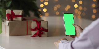 绿色屏幕的手机，圣诞节网上购物的概念