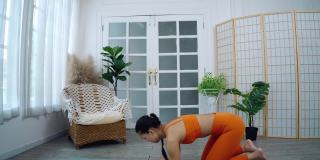 亚洲妇女练习瑜伽，做倒立姿势