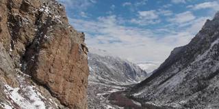 这是初春大雪纷飞的山峡岩石旁的跨度的鸟瞰图。