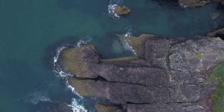 俯瞰岩石的漂亮形状。爱尔兰沃特福德海岸的无人机视频。库珀海岸地质公园。