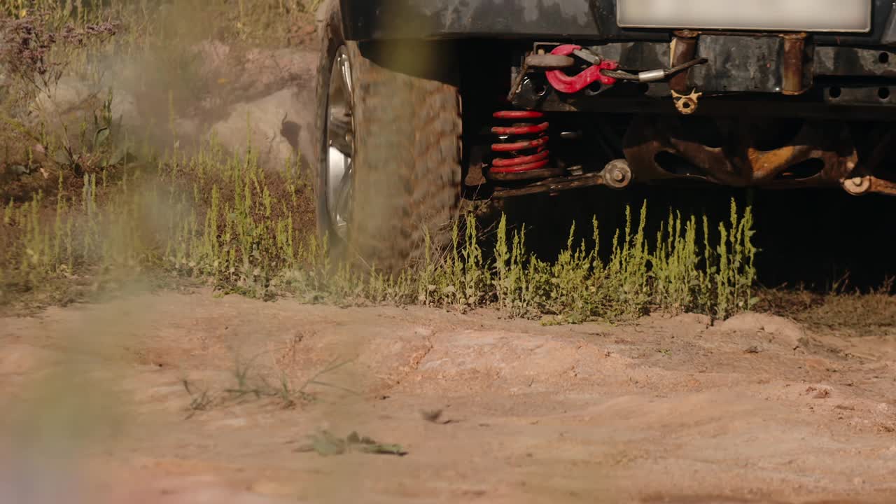 一辆巨大的SUV脏兮兮的车轮正行驶在野外的沙漠路上，特写，俯视。汽车旅行的概念，旅行的欲望