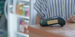 使用信用卡付款的客户。客户使用非接触式信用卡付款，柜台设有读卡机。通过NFC技术接受付款的收银员。