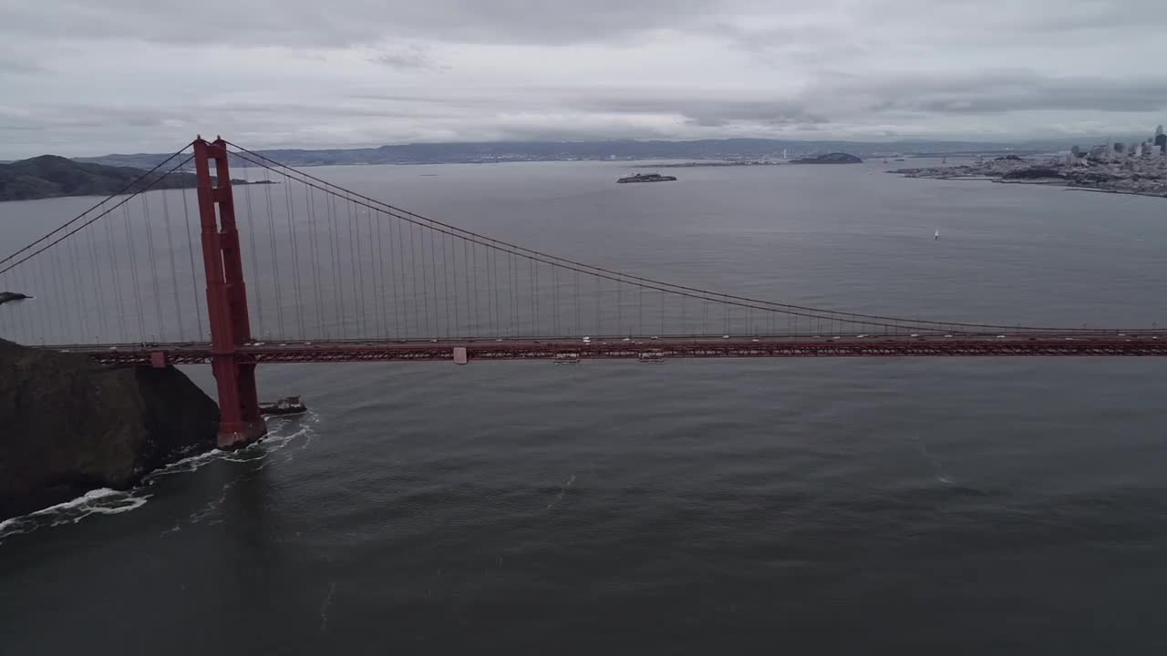 旧金山的金门大桥。多云的一天。观光对象，加州或美国最著名的桥。恶魔岛和监狱的背景。旧金山城市