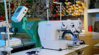 服装厂工业绣花机。在服装制造商的纺织行业，连续绣花机运转迅速视频素材模板下载