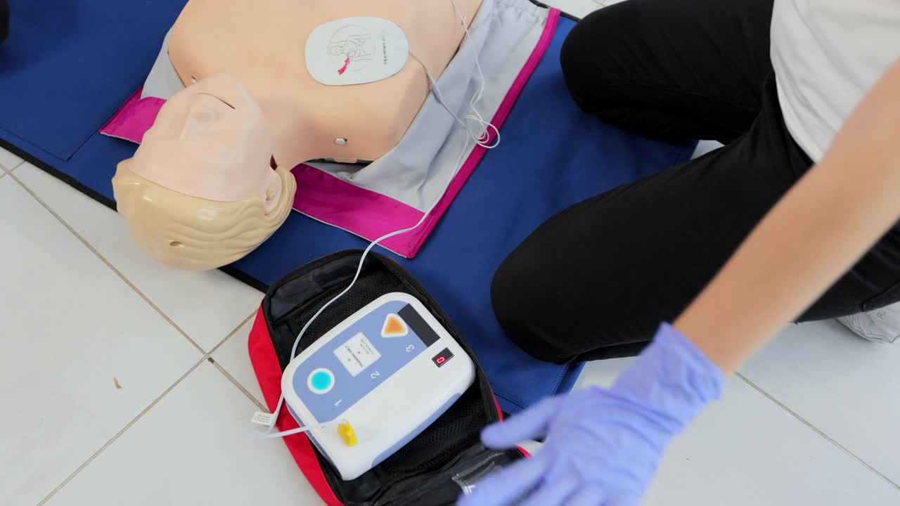心肺复苏术培训医疗程序讲习班。演示胸部按压和AED自动除颤器在心肺复苏玩偶上的使用