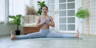 瑜伽亚洲妇女练习瑜伽姿势在她的静修或健身房，保健概念，锻炼
