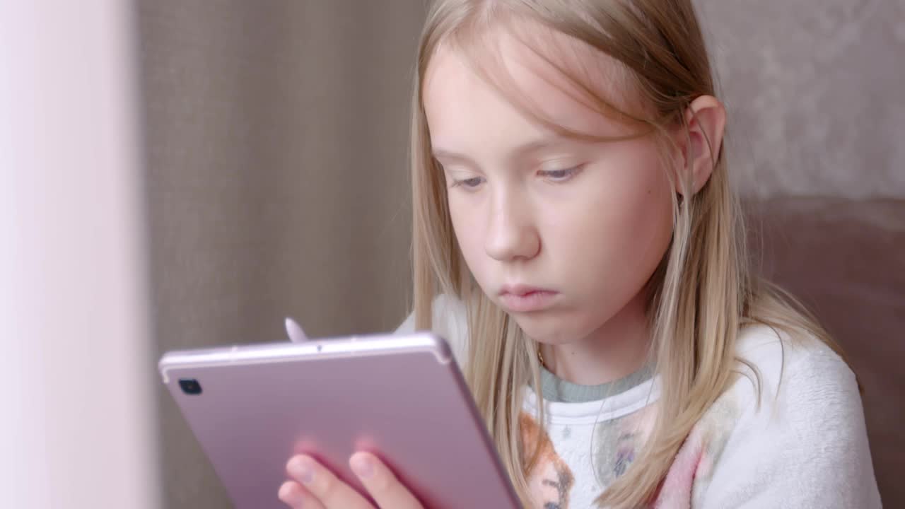 十几岁的女孩在平板电脑上画画。