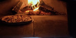 马苏里拉奶酪披萨是在露天的柴火烤箱里烤的。在砖炉里烤披萨。烤披萨店