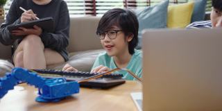 亚洲的孩子们用笔记本电脑给机器人起重机编程，让它们学习科技、数学和工程学。在家编程和编码