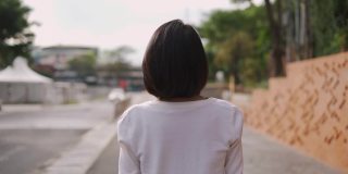 亚洲妇女戴着防护口罩走路