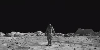 勇敢的宇航员穿着太空服自信地行走在月球表面的阿尔法通道。月球表面，散布着小岩石和沙子。飞越月球环形山。月球表面，沙漠，悬崖，沙子。覆盖在岩石。