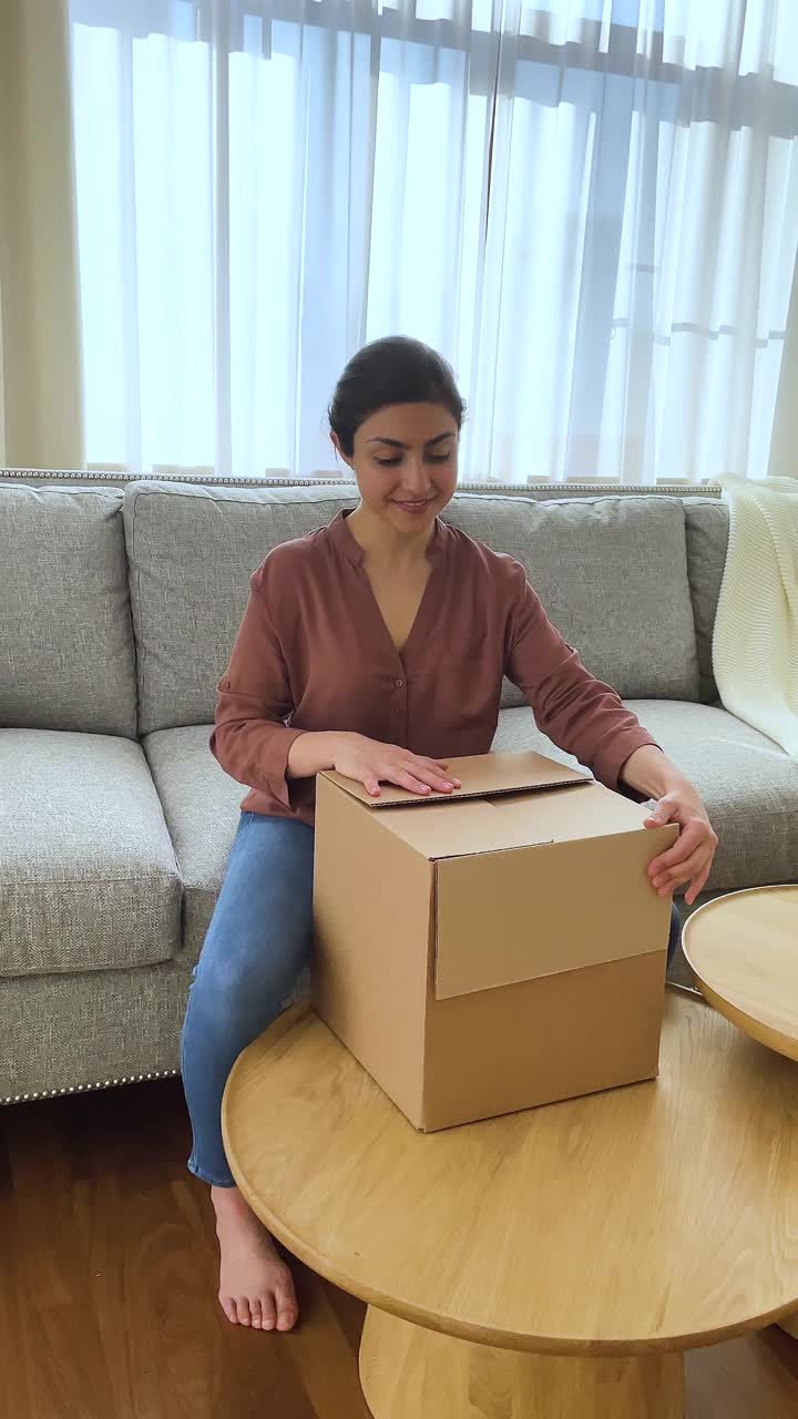 一名印度妇女从包裹中拿出订购的网上礼品盒