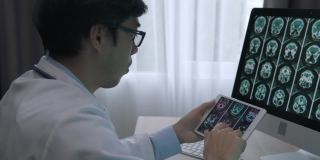 医生用数码平板电脑对病人进行脑部扫描分析