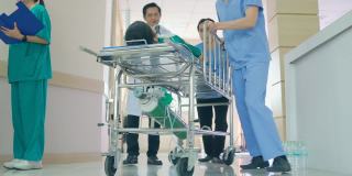 急诊，医生推着病床上的病人沿着医院走廊走。