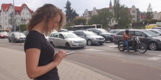 在城市里使用移动电话。一个女人正在寻找一辆免费的汽车旅行。