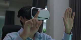 亚洲男子与虚拟现实眼镜耳机触摸空气在家里