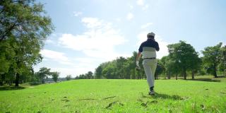 4K亚洲男子高尔夫球在乡村俱乐部在夏天的阳光灿烂的一天。